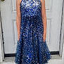 child, girl, smiling, blue_dress, sequins, standing, door, white_door, hoop_earrings, black_shoes, front_door, outdoor, concrete, steps, holiday_decor, decoration, happy, portrait, fashion, casual