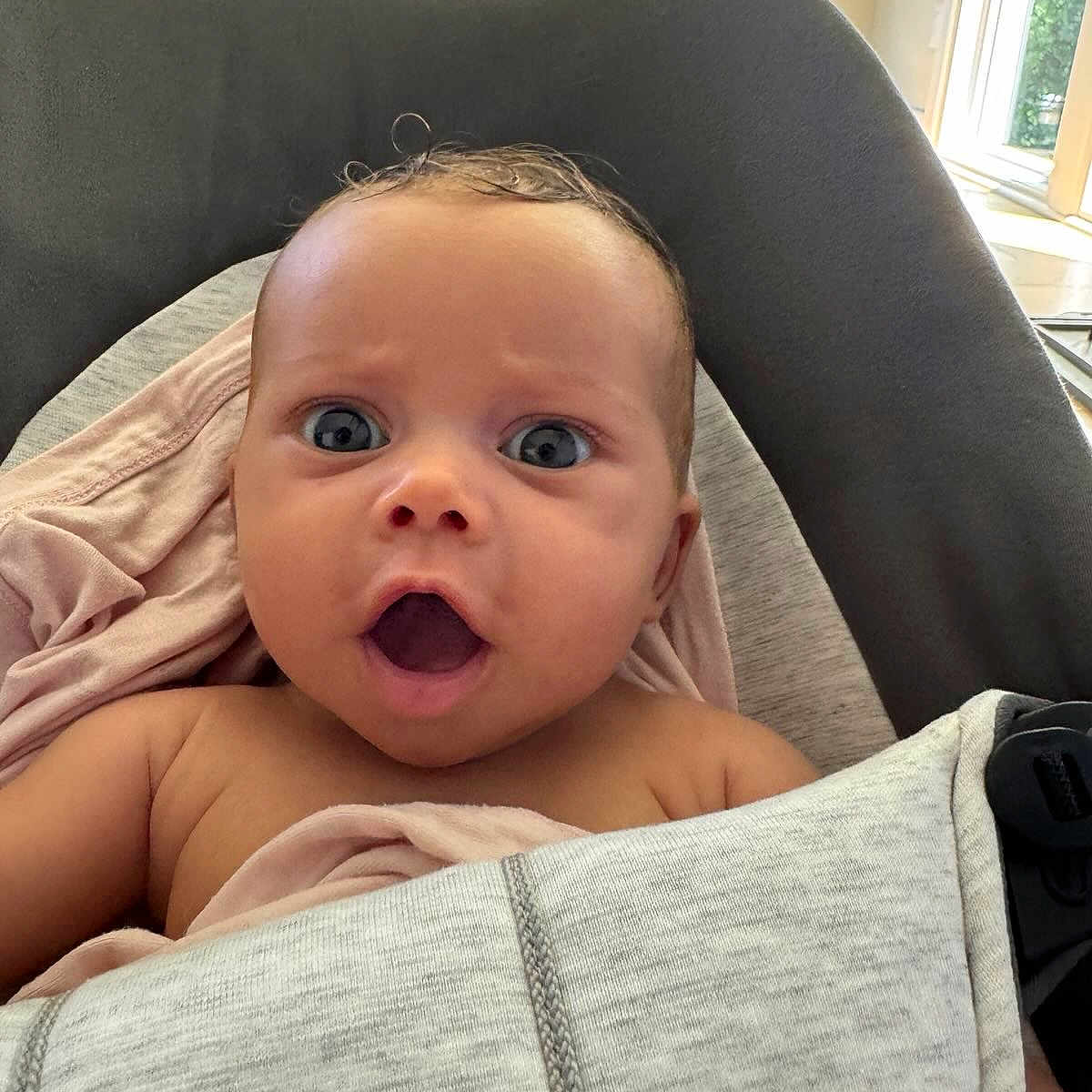 Alvie joined the competition — help win amazing prizes! baby, baby_seat, blanket, blue_eyes, child, closeup, clothing, cushion, expression, face, head, indoors, infant, natural_light, person, portrait, seat, skin, surprised, window