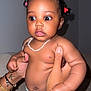 Kaëline participe au concours pour gagner de l'argent avec cette photo : baby, bracelet, child, closeup, curly_hair, cute, diaper, expression, hair_ties, hands, holding, indoor, infant, necklace, person, portrait, skin, sofa, tattoo, wide_eyes
