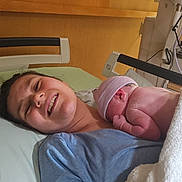 Chelsea joined the competition — help win amazing prizes! woman, newborn, baby, hospital, bed, smile, skin_to_skin, mother, child, cap, blanket, medical_equipment, hospital_room, person, new_mother, joy, family, love, healthcare, postpartum