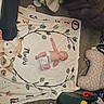 Chelsea joined the competition — help win amazing prizes! baby, infant, child, diaper, lying_down, blanket, stuffed_animals, nursery, baby_gear, indoor, floor, carpet, toys, bottle, play_mat, household_items, portrait, overhead_view, cluttered_room, photography