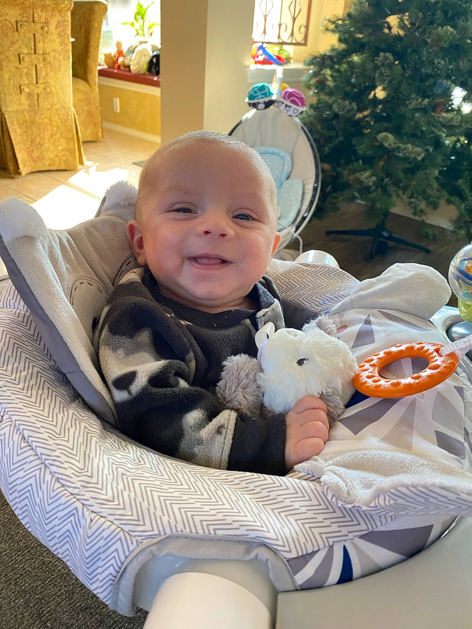 Robby joined the competition — help win amazing prizes! baby, baby_products, baby_toddler_clothing, chair, child, christmas_ornament, comfort, event, fun, happy, holiday, holiday_ornament, lap, person, room, sitting, smile, toddler, toy, tree