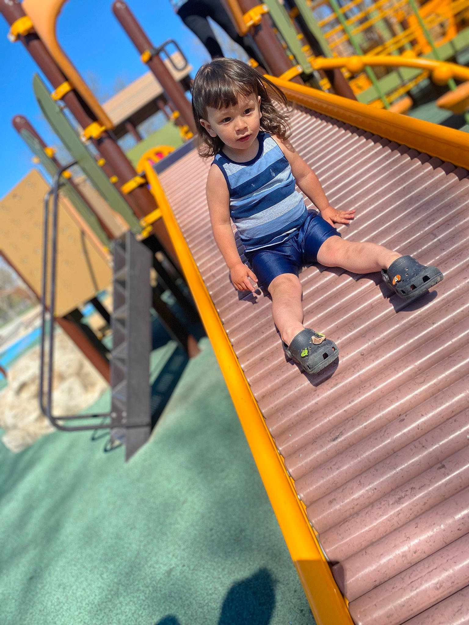 Adrian is registered to the contest to win money with this photo: baby, baby_toddler_clothing, blue, child, city, electric_blue, fun, happy, leisure, nonbuilding_structure, outdoor_play_equipment, person, play, playground, recreation, shorts, sky, snapshot, toddler, vacation