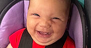 Maelani is registered to the contest to win money with this photo: baby, baby_boy, baby_girl, butterfly_pattern, car_seat, child, closeup, cute, face, happy, head, indoor, infant, person, portrait, red_clothing, seat, seatbelt, smiling, young_child