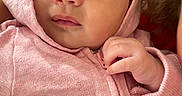 Maelani joined the competition — help win amazing prizes! baby, infant, hood, pink_clothing, face, hand, skin, portrait, cute, newborn, child, human, eyes, expression, soft_light, indoors, warm, baby_garment, peaceful, closeup