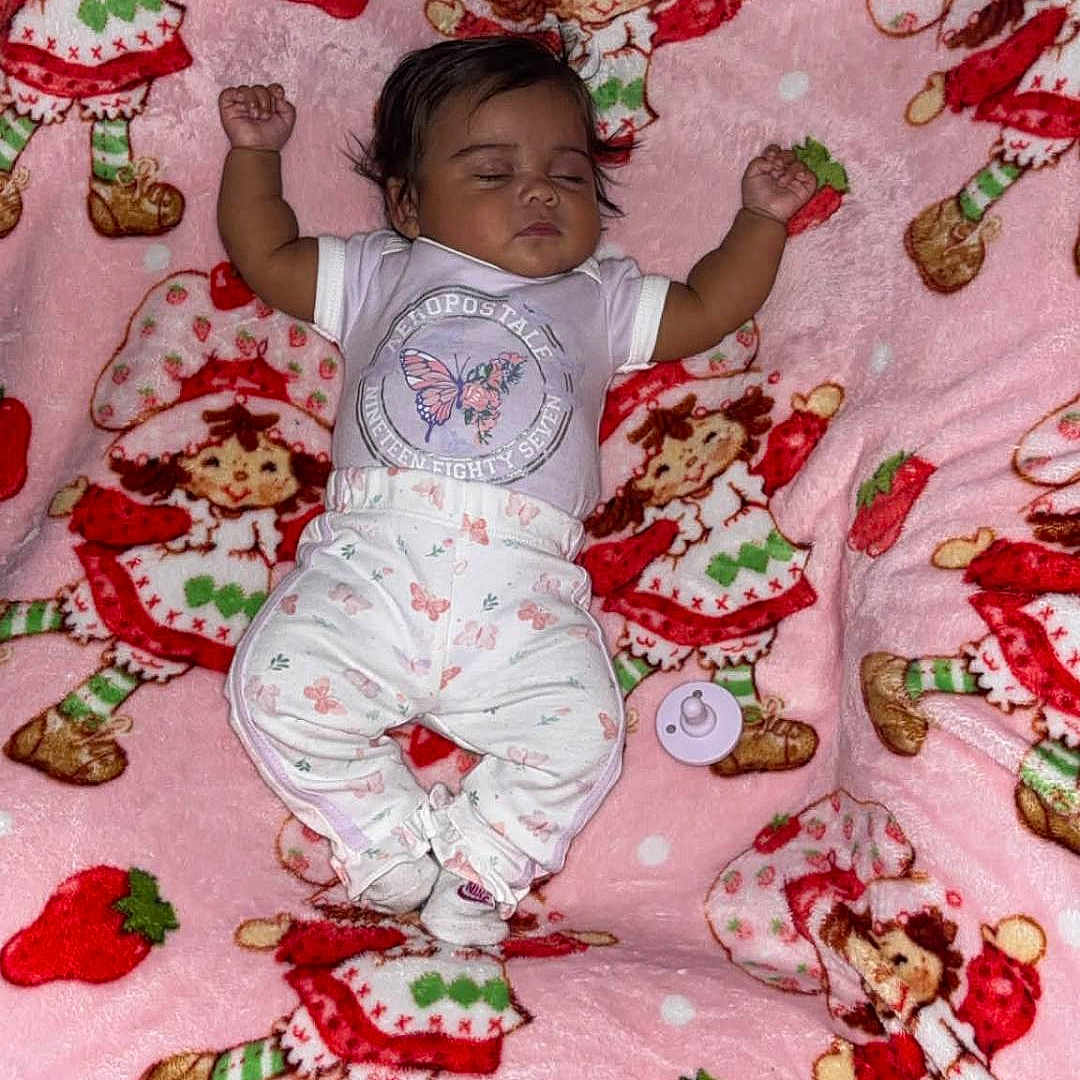 Ka'Mylah Perry joined the competition — help win amazing prizes! baby, sleeping, blanket, pink, strawberry_shortcake, strawberries, child, pacifier, clothing, socks, cute, indoors, resting, pattern, soft, toy, infant, comfort, cute_outfit, lying_down