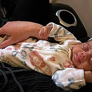 Ka'Mylah Perry is registered to the contest to win money with this photo: baby, sleeping, infant, hand, onesie, hat, floral_pattern, cute, cozy, rest, peaceful, indoor, cushion, black_clothing, skin, portrait, newborn, relaxation, child, person