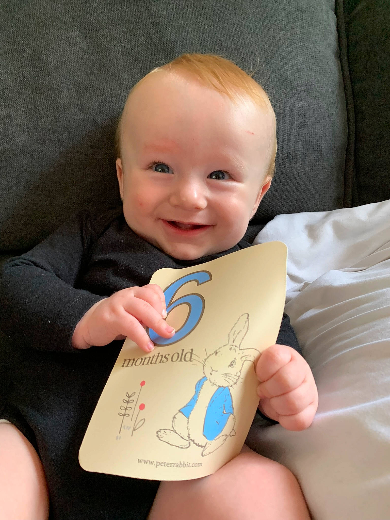Kaden joined the competition — help win amazing prizes! baby, baby_toddler_clothing, cheek, child, comfort, facial_expression, finger, fun, gesture, happy, joy, nail, person, product, room, sitting, skin, sleeve, smile, thumb