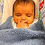 Pahal is registered to the contest to win money with this photo: baby, blanket, sleeping, child, face, hand, cozy, cute, indoors, fabric, pattern, blue, soft, peaceful, nap, infant, closeup, portrait, warm, wrapped