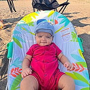 Pahal joined the competition — help win amazing prizes! baby, infant, child, cap, red_clothing, baby_seat, beach, sand, outdoor, sunlight, trees, chair, blue_sky, person, footwear, socks, summer, recreation, relaxation, nature