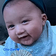 Chozien joined the competition — help win amazing prizes! baby, child, infant, portrait, close_up, face, eyes, serious_expression, gray_clothing, blue_clothing, head, cheeks, short_hair, sitting, indoor, soft_lighting, dark_background, photography, text_overlay, heart