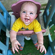 Asher joined the competition — help win amazing prizes! baby, child, swing, playground, outdoor, happy, smiling, yellow_shirt, blue_eyes, grass, plastic, toy, play, cute, infant, hands, feet, casual_clothing, daylight, fun