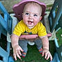 baby, child, swing, playground, outdoor, happy, smiling, yellow_shirt, blue_eyes, grass, plastic, toy, play, cute, infant, hands, feet, casual_clothing, daylight, fun
