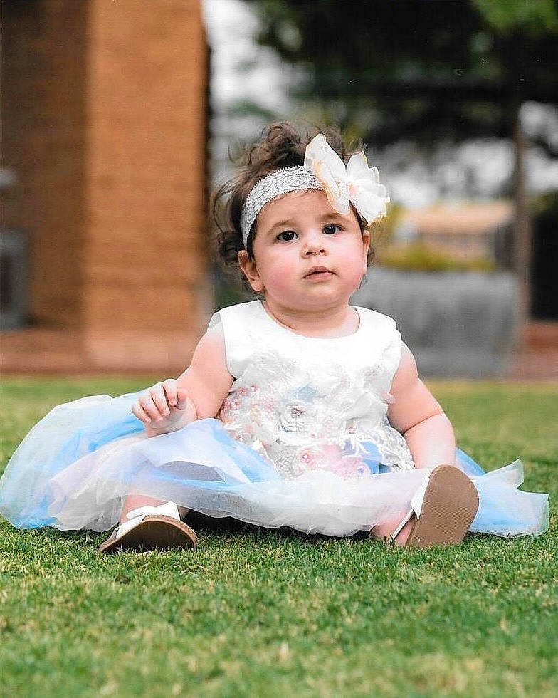 Meilani is registered to the contest to win money with this photo: baby, baby_toddler_clothing, beauty, child, child_model, costume_accessory, dress, embellishment, eye, face, hair_accessory, headband, headpiece, headwear, mouth, nose, person, pink, portrait_photography, shoe