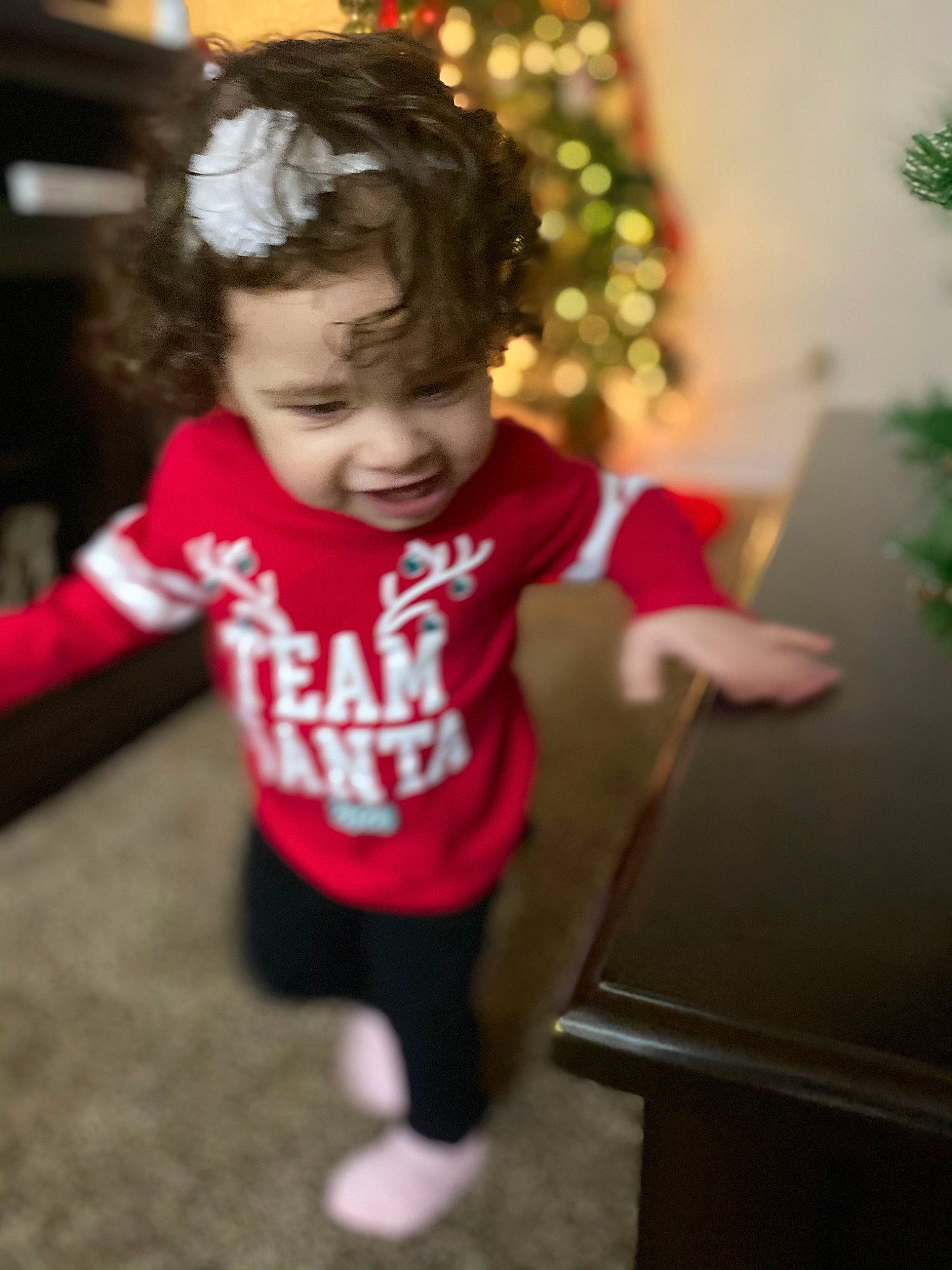 Meilani joined the competition — help win amazing prizes! baby, baby_toddler_clothing, child, christmas, christmas_decoration, christmas_eve, christmas_ornament, christmas_tree, conifer, fir, holiday, holiday_ornament, laugh, nightwear, ornament, person, pine_family, play, sleeve, standing