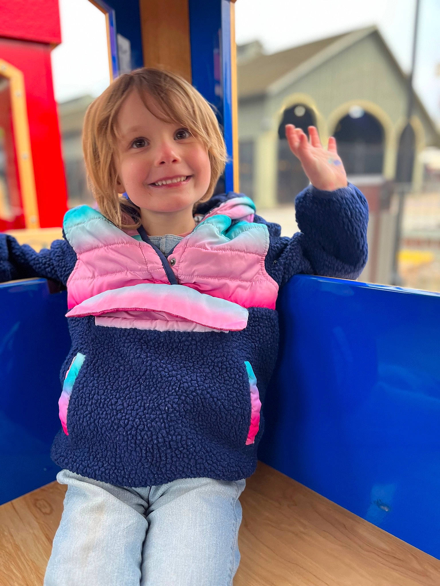 Faye is registered to the contest to win money with this photo: baby_toddler_clothing, blue, child, comfort, denim, electric_blue, flooring, fun, happy, joy, leisure, magenta, outdoor_play_equipment, outerwear, person, recreation, sitting, sleeve, smile, standing