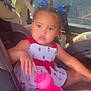 toddler, child, car_seat, sippy_cup, dress, blue_bow, sunlight, car_interior, window, seatbelt, face, person, cute, indoors, vehicle, sitting, young_child, summer, bright, expression