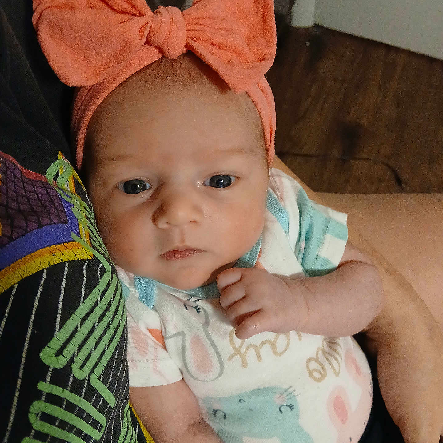 Makenna Layne joined the competition — help win amazing prizes! animal_print, arm, baby, bow, child, closeup, clothing, cute, face, floor, headband, holding, human, indoor, infant, looking, onesie, person, portrait, wooden_floor