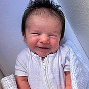 Reginald joined the competition — help win amazing prizes! baby, infant, smile, face, hair, white_clothing, onesie, blanket, wrapped, newborn, happy, cute, portrait, human, skin, indoors, closeup, child, expression, resting