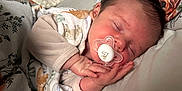 Reginald is registered to the contest to win money with this photo: baby, bed, blanket, child, clothing, cozy, cute, face, hands, indoors, infant, newborn, pacifier, peaceful, pillow, portrait, rest, sleeping, soft, young