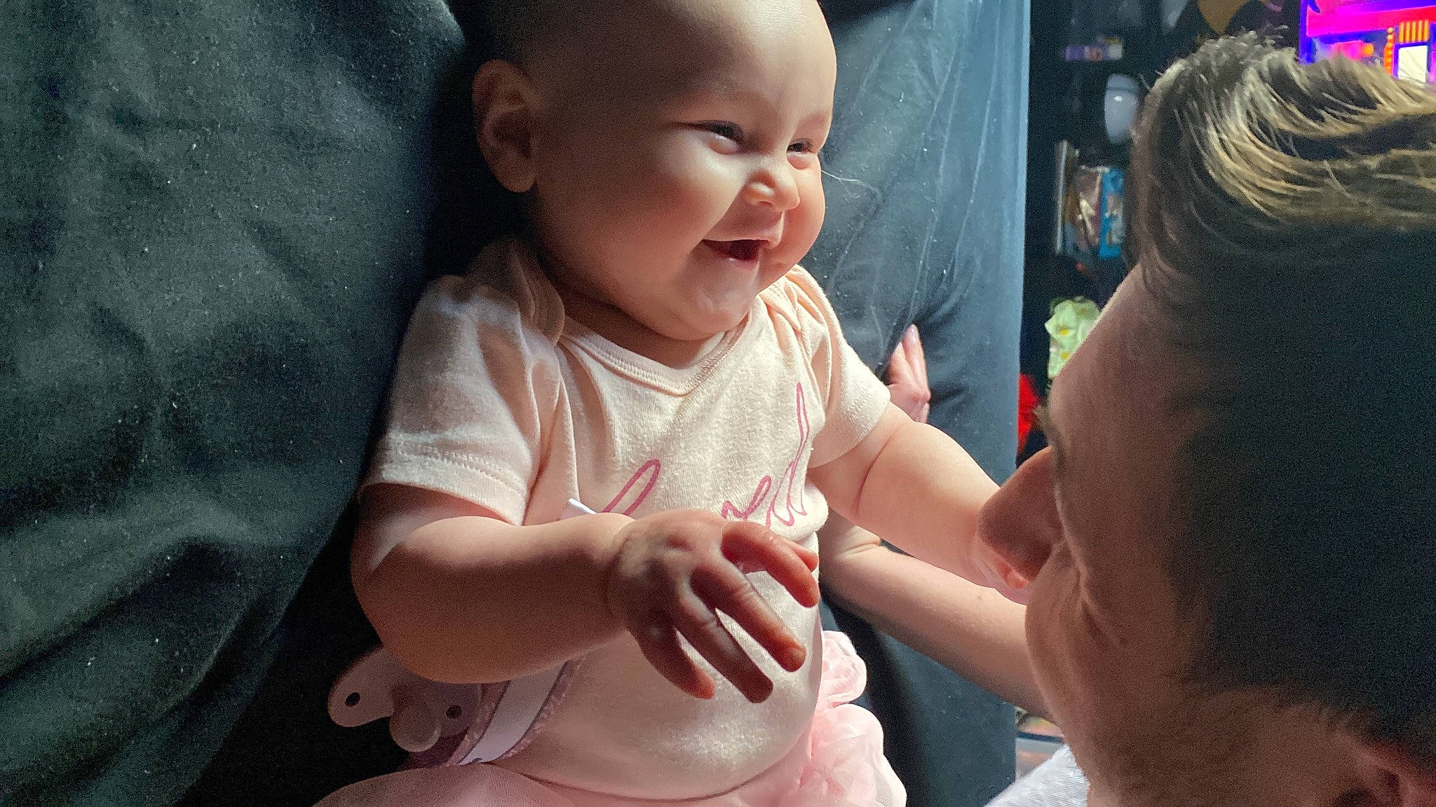 Alani is registered to the contest to win money with this photo: baby, baby_toddler_clothing, cheek, child, event, facial_expression, finger, fun, gesture, hand, happy, human, human_body, interaction, mouth, nose, person, skin, smile, thumb