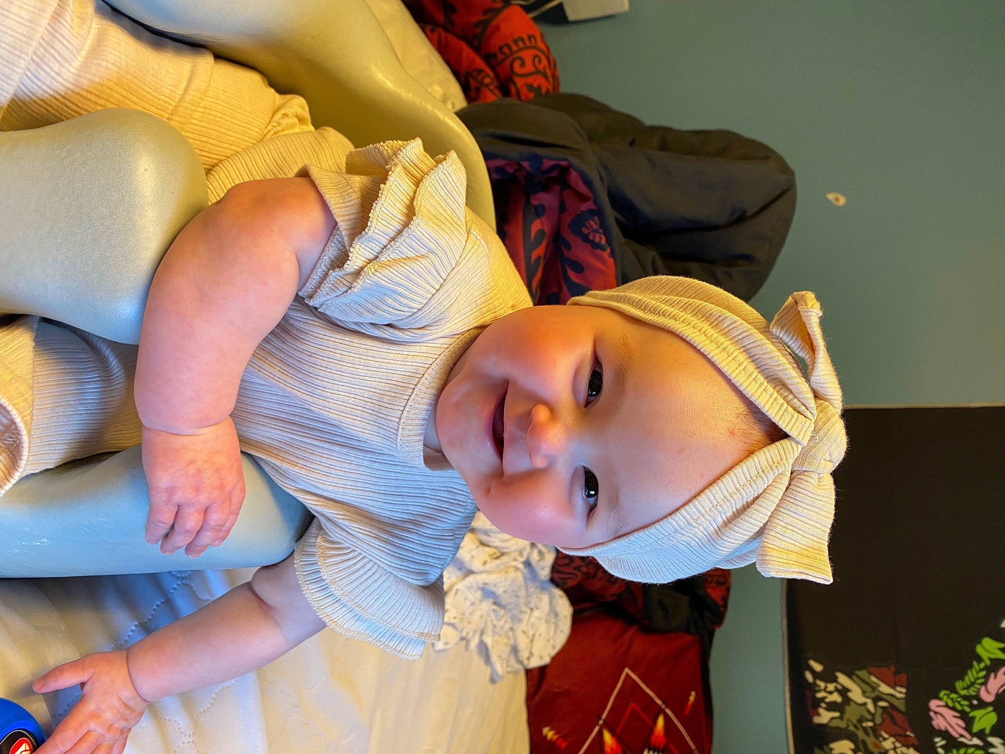 Alani is registered to the contest to win money with this photo: baby, child, comfort, eyewear, fashion_accessory, fun, happy, hat, headgear, headwear, joy, leisure, linens, lip, mouth, person, plant, room, smile, sun_hat
