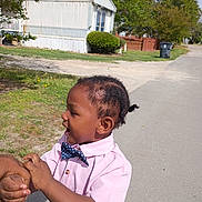 Datwan joined the competition — help win amazing prizes! child, toddler, boy, portrait, outdoor, suburban, street, pink_shirt, bow_tie, polka_dots, short_hair, smiling, side_profile, adult_hand, walking, daylight, trees, house, grass, dandelions