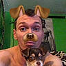 man, dog, puppy, face_filter, selfie, indoor, shirtless, green_wall, poster, bed, holding, cute, pet, playful, expression, young_adult, brown_eyes, short_hair, digital_filter, animal