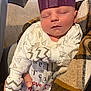 Jaxon joined the competition — help win amazing prizes! baby, newborn, sleeping, crown, purple, mittens, person, plaid, jacket, hand, carpet, indoor, clothing, pattern, cozy, resting, child, infant, holding, soft