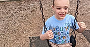 Theodore joined the competition — help win amazing prizes! child, boy, swing, playground, chains, shorts, tshirt, smiling, outdoor, park, fence, tree, grass, skatepark, woodchips, footwear, happy, summer, recreation, casual