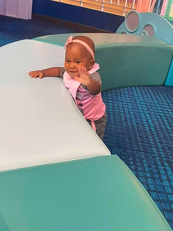 Kayla joined the competition — help win amazing prizes! baby, baby_toddler_clothing, child, comfort, flooring, fun, games, green, leisure, linens, magenta, person, play, recreation, room, sitting, t_shirt, table, textile, toddler