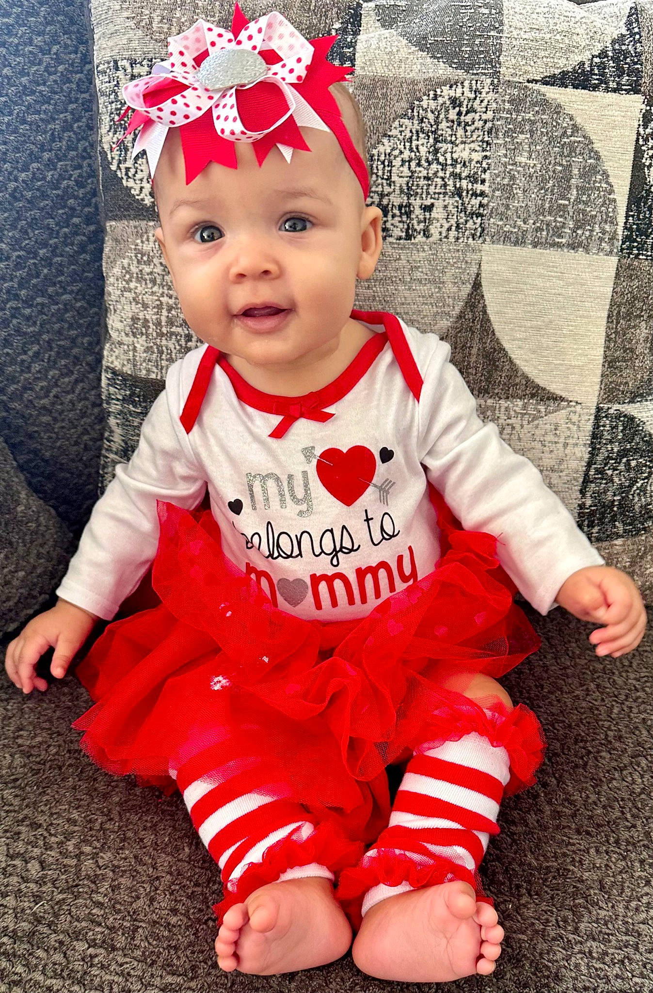 Sariyah is registered to the contest to win money with this photo: baby, baby_toddler_clothing, cap, cool, costume_hat, face, fictional_character, grass, happy, hat, headgear, headwear, outerwear, pattern, person, pink, red, sleeve, smile, t_shirt