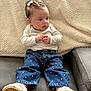 Alessia is registered to the contest to win money with this photo: baby, infant, child, sitting, couch, blanket, denim_pants, polka_dots, shoes, hair_bows, earrings, long_sleeve, hands, portrait, cute, indoor, cozy, fabric_texture, expression, relaxed_pose