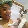 Oreo joined the competition — help win amazing prizes! person, cat, kitten, indoor, smiling, headwrap, window, blinds, hand, animal, pet, face, holding, white_cat, black_spots, jewelry, necklace, casual_clothing, home, portrait