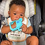 baby, car_seat, teething_toy, bib, socks, infant, child, cute, portrait, indoor, striped, headrest, clothing, seatbelt, smiling, baby_toy, closeup, cute_baby, young_child, happy