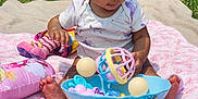 Amaya is registered to the contest to win money with this photo: baby, blanket, bowl, child, colorful, cute, foot, grass, infant, nature, outdoor, person, plastic, play, relax, sitting, summer, sunlight, toy, water_mat