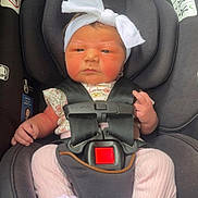 Oaklynn joined the competition — help win amazing prizes! baby, infant, car_seat, headband, white_bow, pink_pants, socks, straps, black_car_seat, child, newborn, cute, serious_face, indoors, sitting, safety_harness, person, clothing, small_hands, portrait