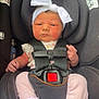 baby, infant, car_seat, headband, white_bow, pink_pants, socks, straps, black_car_seat, child, newborn, cute, serious_face, indoors, sitting, safety_harness, person, clothing, small_hands, portrait