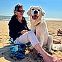 dog, golden_retriever, woman, beach, sand, ocean, towel, sunlight, smile, leash, sunglasses, casual_clothing, barefoot, blue_sky, outdoor, relaxation, vacation, pet, summer, nature