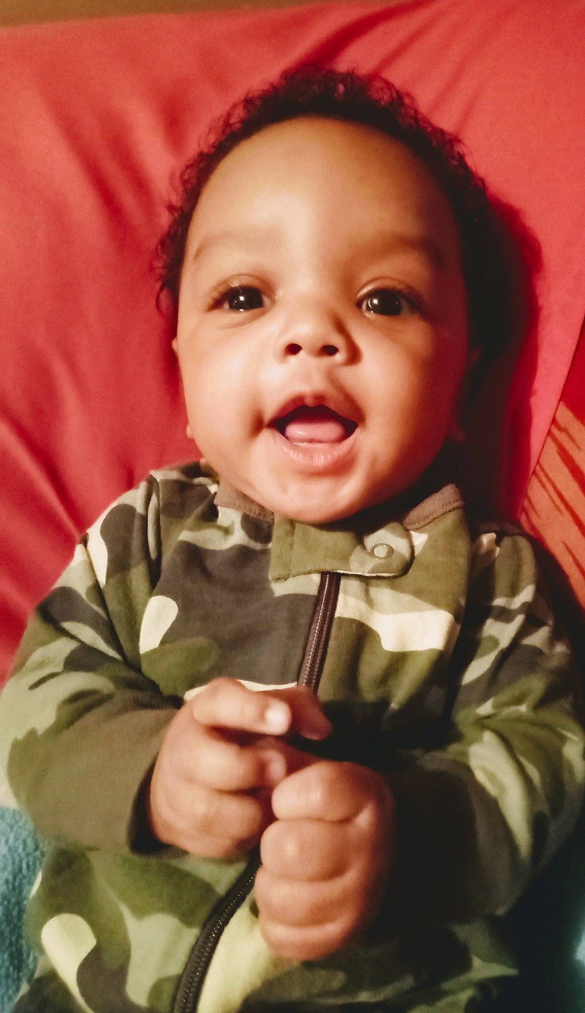 Justus is registered to the contest to win money with this photo: baby, baby_toddler_clothing, cheek, chin, collar, eye, facial_expression, finger, gesture, happy, head, human_body, lip, mouth, nose, outerwear, person, skin, sleeve, smile