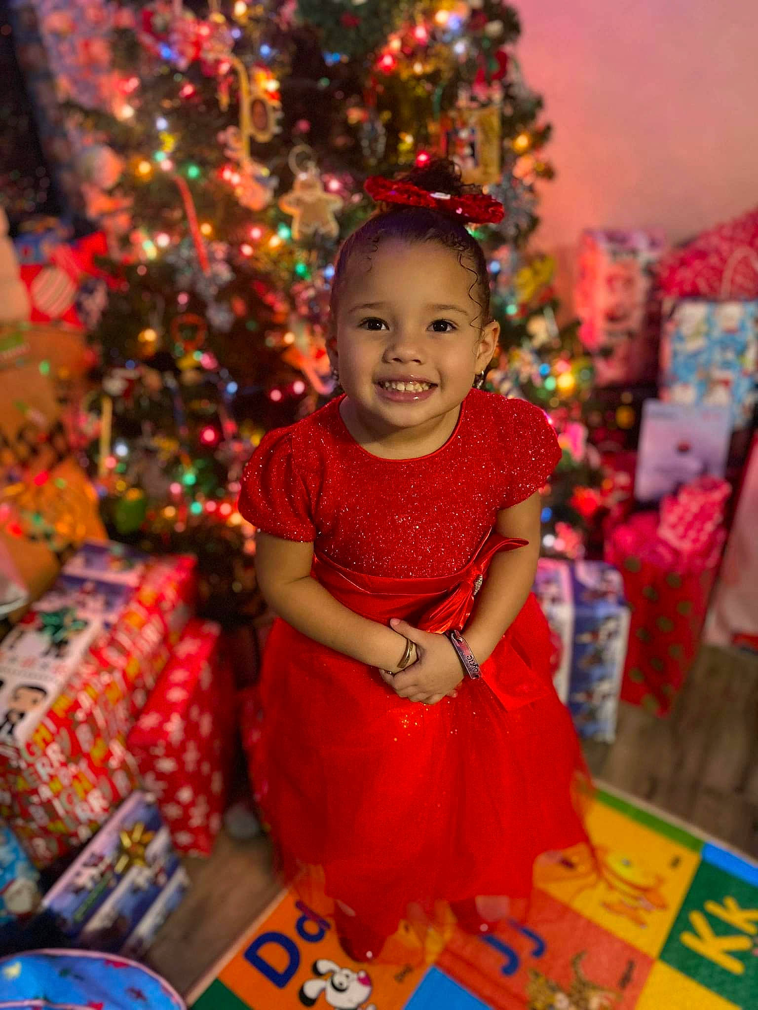 Lyric joined the competition — help win amazing prizes! child, christmas, christmas_decoration, christmas_eve, christmas_ornament, christmas_tree, conifer, dress, event, fun, happy, holiday, holiday_ornament, joy, magenta, ornament, party_supply, person, smile, standing