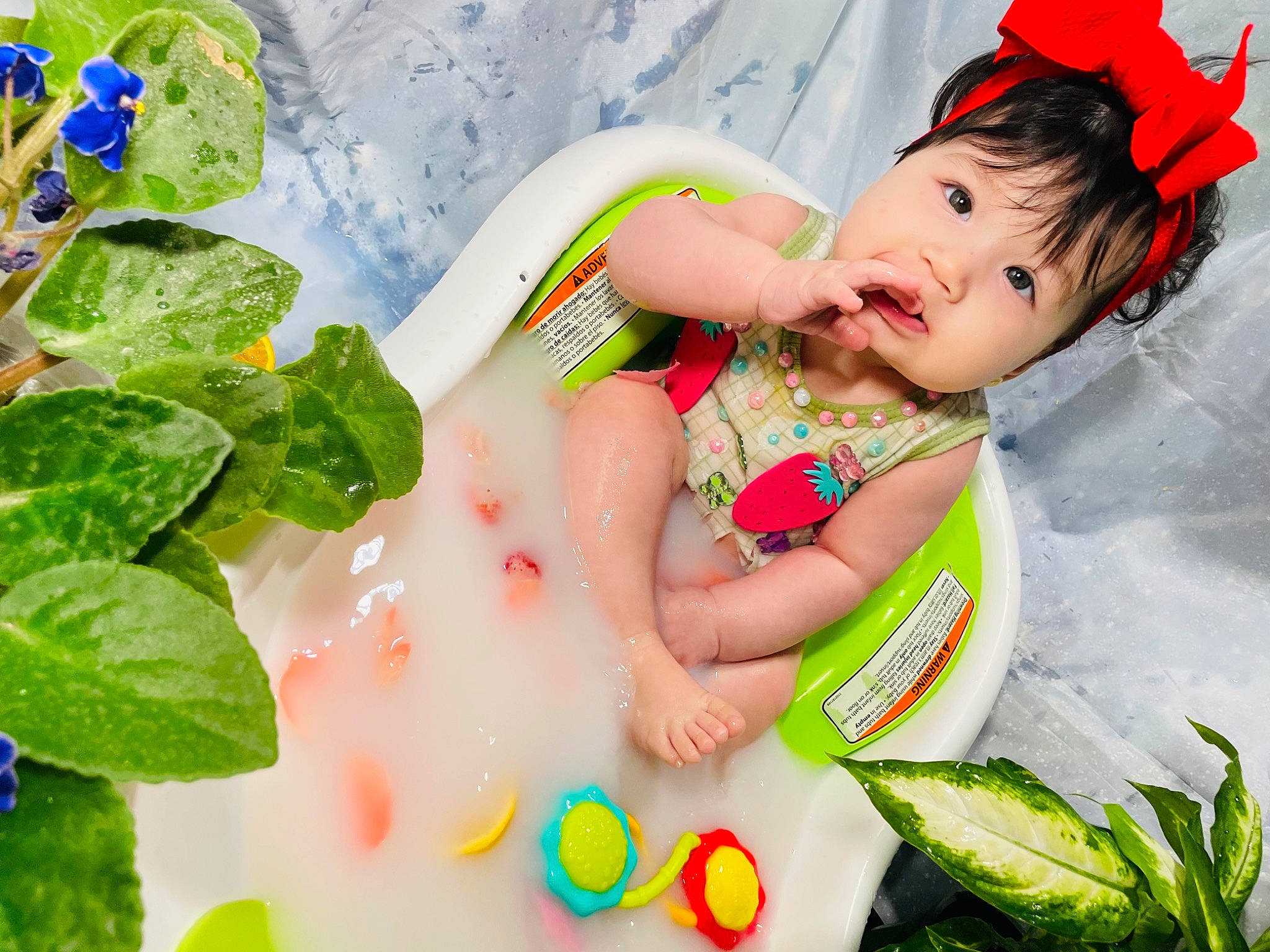 Guadalupe is registered to the contest to win money with this photo: baby, baby_toddler_clothing, bathing, child, fictional_character, fun, grass, green, happy, headband, headpiece, leisure, people_in_nature, person, play, recreation, skin, sweetness, toddler, toy