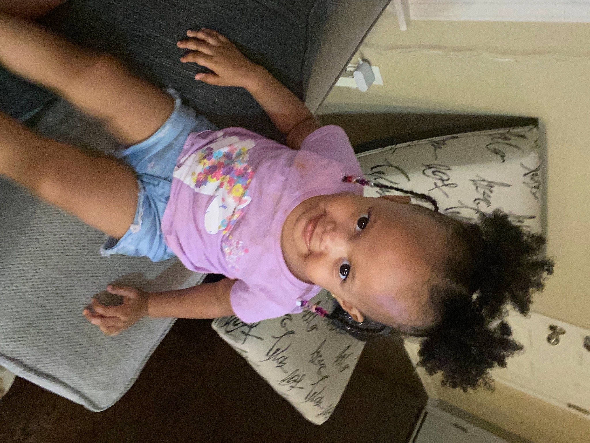 Gianna is registered to the contest to win money with this photo: arm, baby, baby_toddler_clothing, cheek, child, comfort, cool, elbow, finger, fun, gesture, handwriting, happy, human_leg, joy, mouth, person, room, thigh, thumb