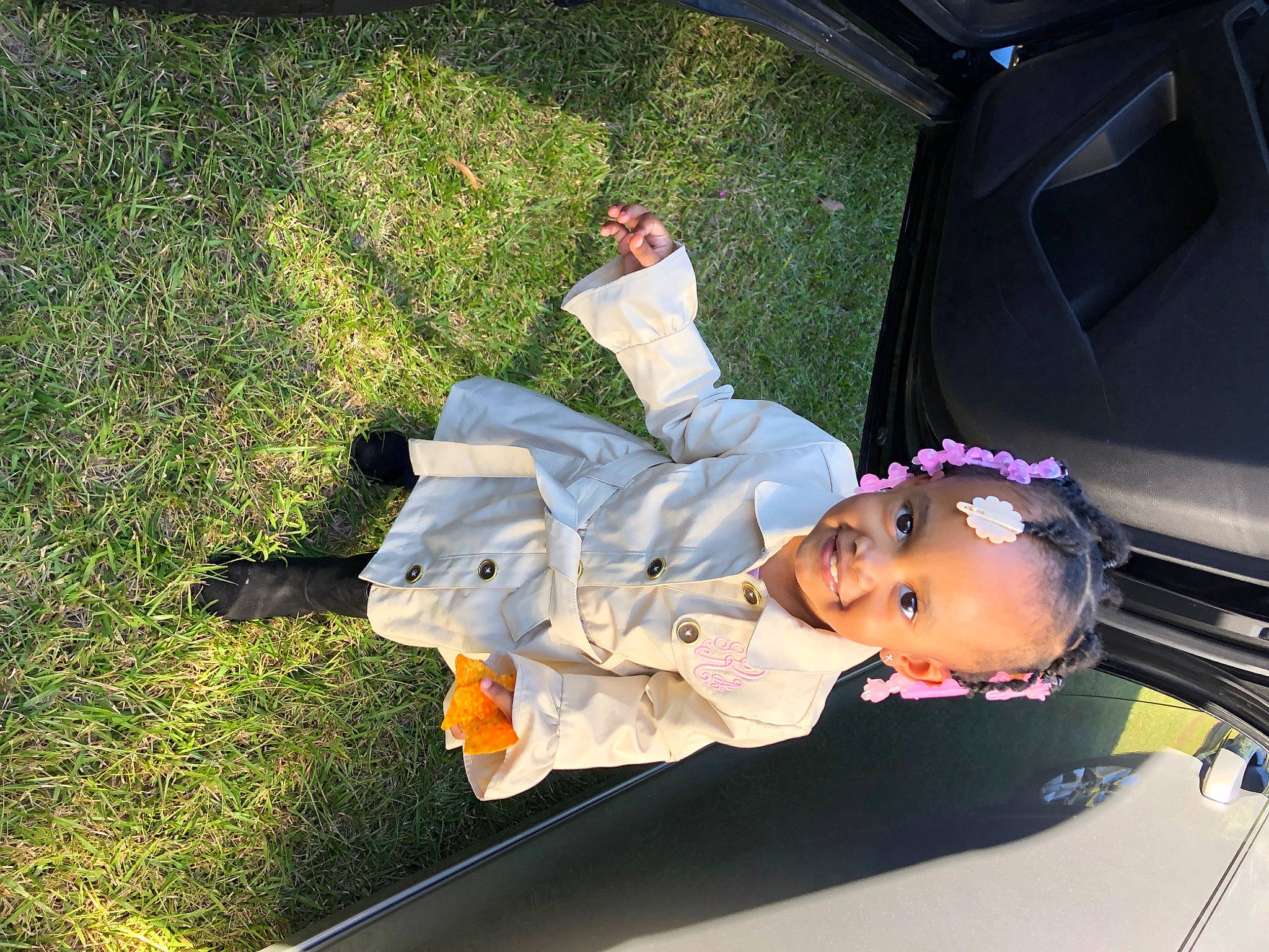 Giselle is registered to the contest to win money with this photo: auto_part, automotive_window_part, black_hair, car, child, cool, family_car, grass, joy, leisure, luxury_vehicle, person, plant, toddler, tree, vacation, vehicle, vehicle_door