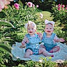 baby, babies, denim_overalls, headband, flower, garden, blanket, outdoor, greenery, plants, smiling, happy, cute, child, nature, sunlight, infant, pink_flowers, sitting, portrait