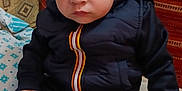 Solan a rejoint le concours — aidez-le/la à gagner de superbes lots ! black_clothing, child, couch, cozy, cushion, expression, face, foot, hair, hand, indoor, jacket, pants, pattern, person, portrait, serious, sitting, toddler, young