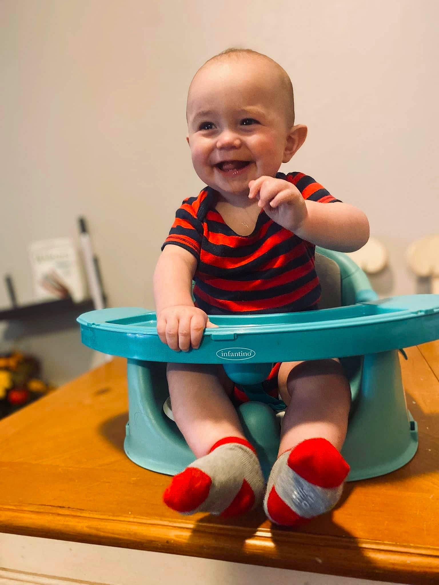 Keegan is registered to the contest to win money with this photo: arm, baby, baby_playing_with_toys, baby_toddler_clothing, balance, child, electric_blue, facial_expression, finger, fun, happy, human_leg, joy, knee, leisure, person, red, sitting, sleeve, smile