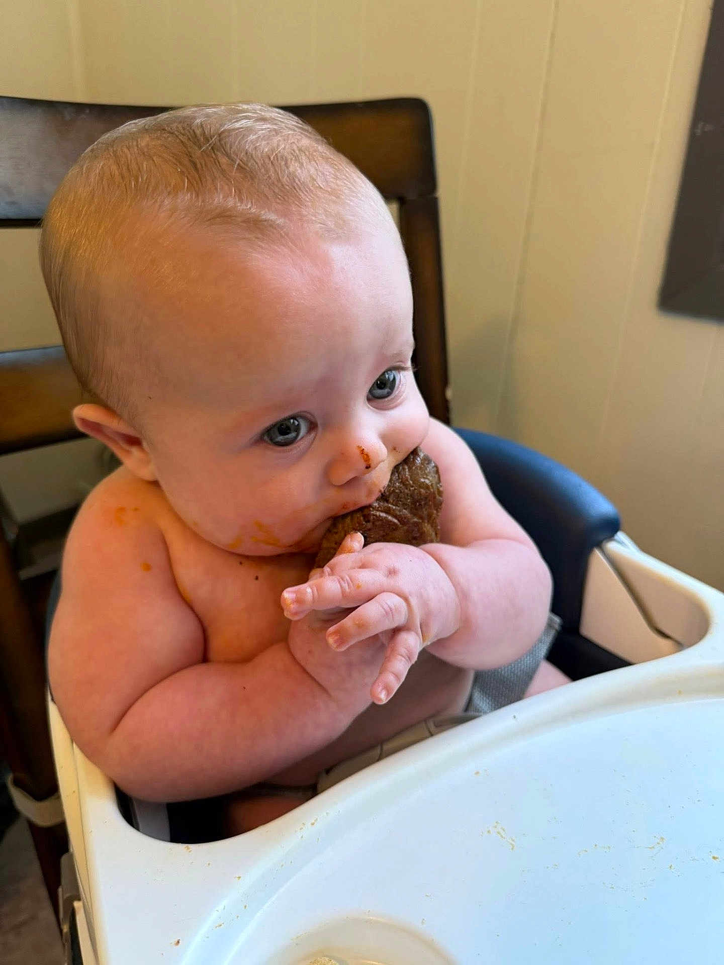 Jaxxon joined the competition — help win amazing prizes! baby, high_chair, cookie, messy, food, child, indoor, cute, hands, face, eating, snack, table, seat, chubby, skin, blue_eyes, expression, concentration, infant
