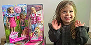 Emy participe au concours pour gagner de l'argent avec cette photo : child, girl, smile, toy, barbie, doll, packaging, box, curly_hair, standing, indoor, happy, clothing, floor, tile, play, present, cute, young, person