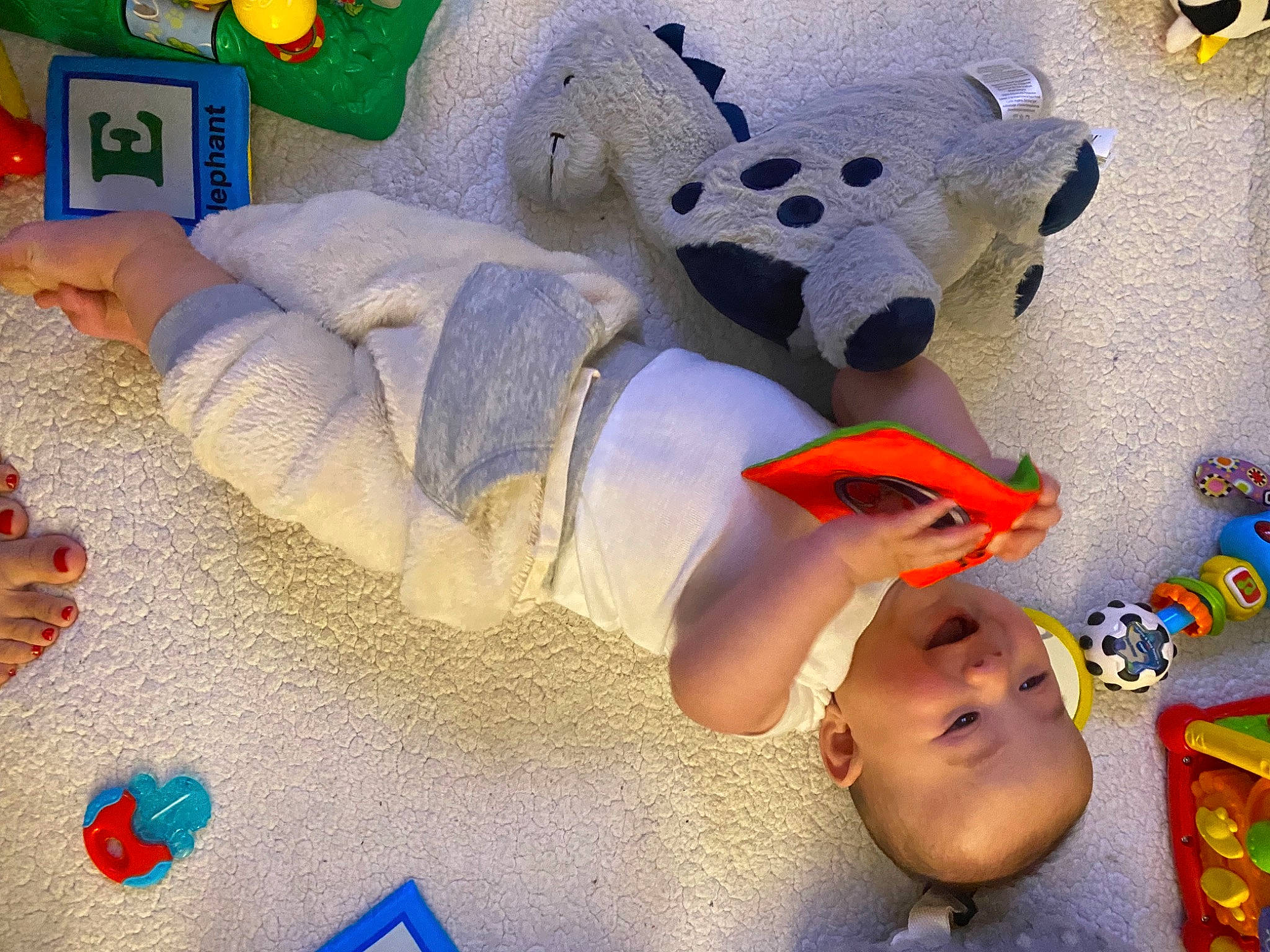 Bjorn is registered to the contest to win money with this photo: art, baby, baby_products, baby_toddler_clothing, baby_toys, child, comfort, flooring, fun, linens, pattern, person, plastic, play, plush, room, stuffed_toy, toddler, toy, visual_arts